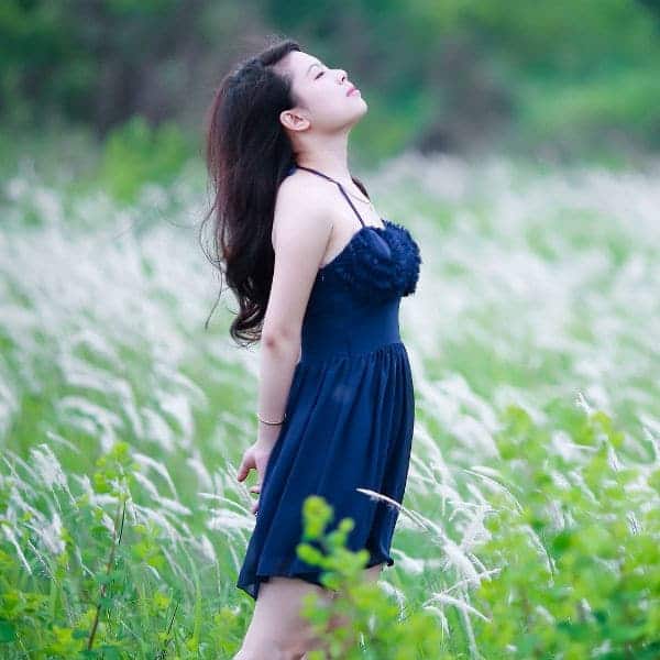 Raw Horizons woman in a blue dress in a green field