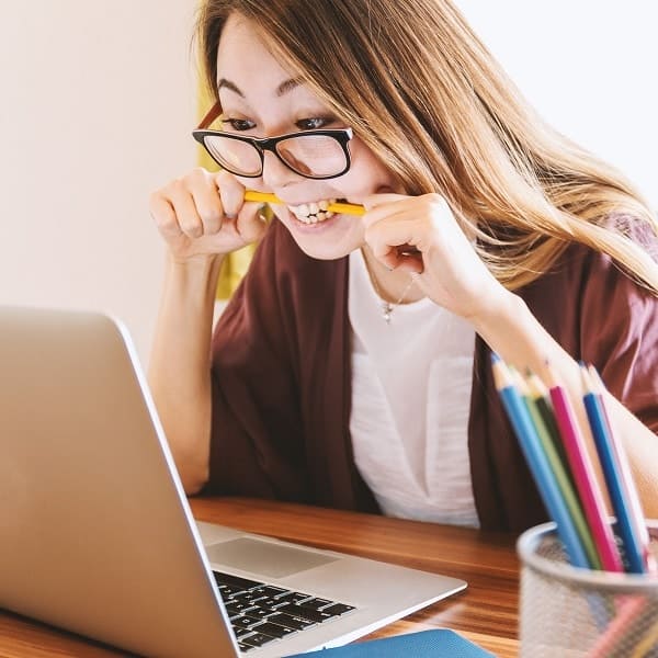 Focused Student with Laptop and Pencils
