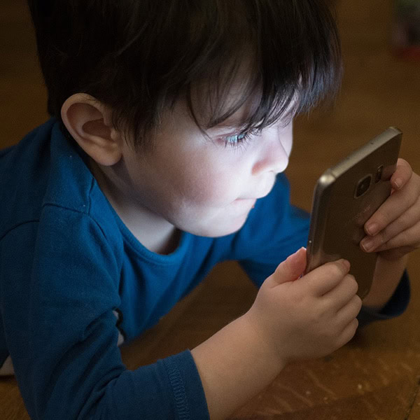 Raw Horizons Child Using Smartphone