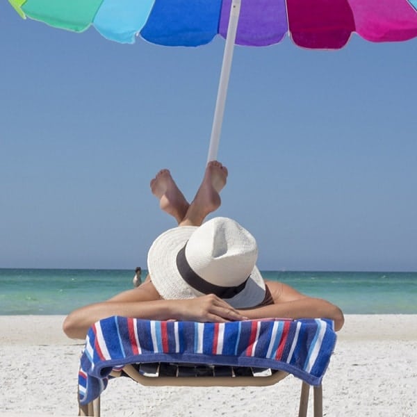 Beach relaxation with umbrella and sunbather