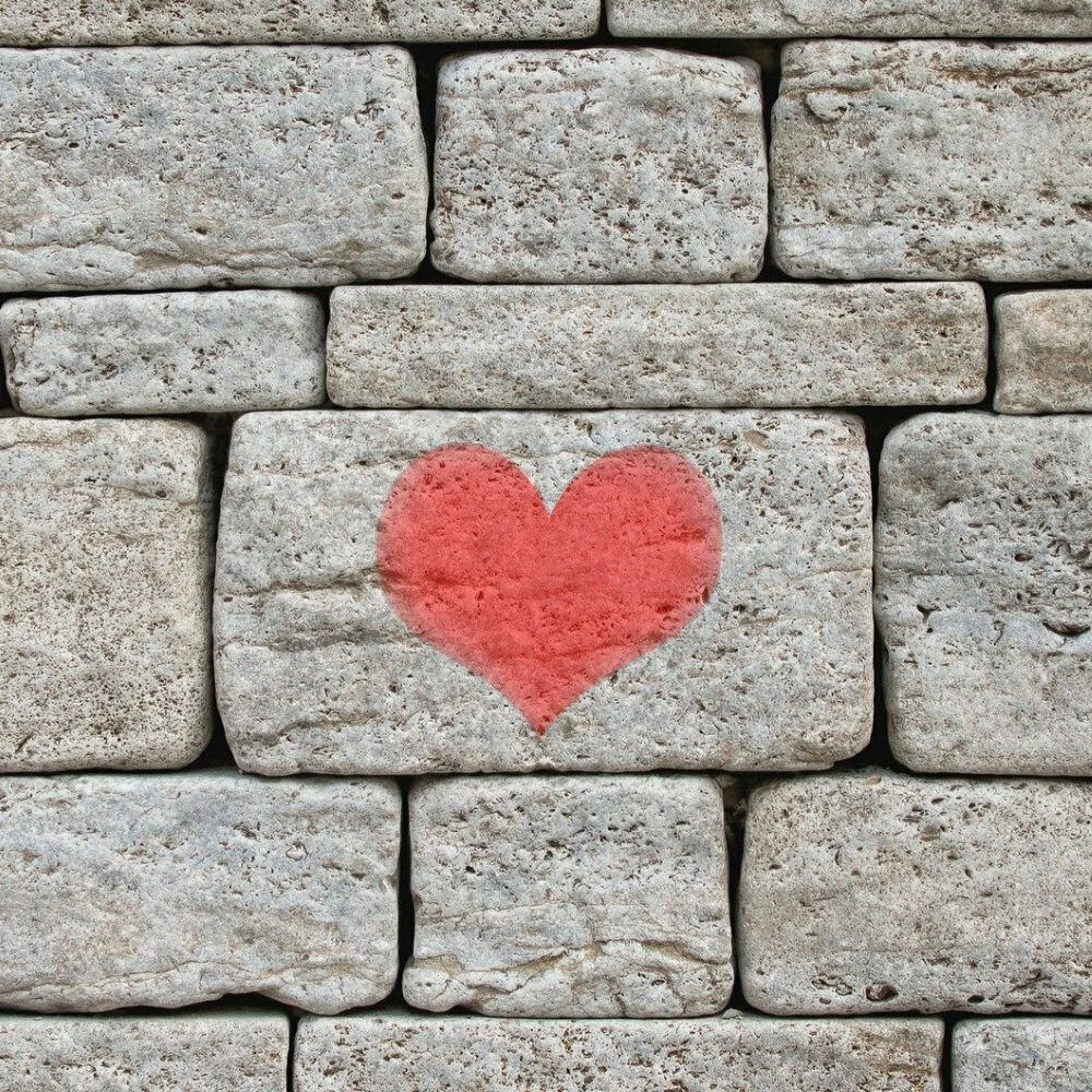 Heart graffiti on stone wall for urban art and love symbolism