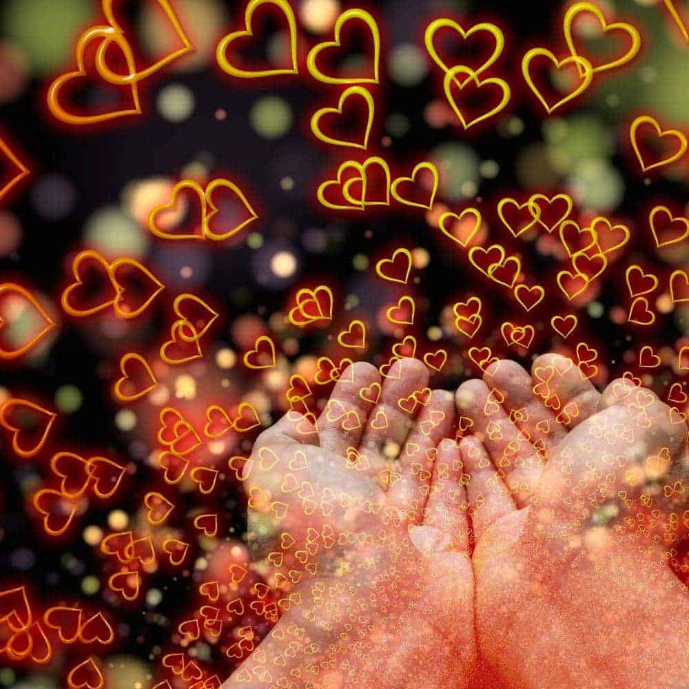 Love and connection concept with glowing hearts and hands.