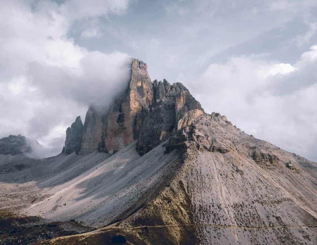 Stunning mountain landscape featuring towering peaks and dramatic cloud formations.