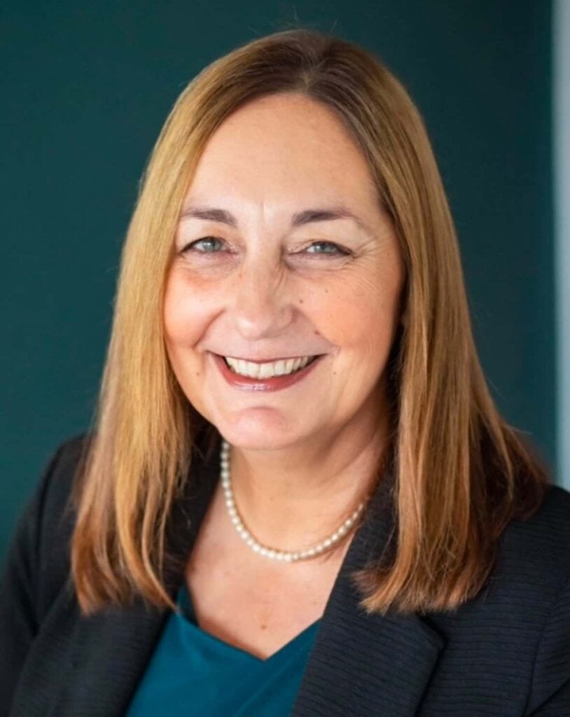 Woman smiling, health and wellness coaching at Raw Horizons.