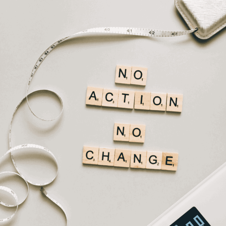 Wooden Scrabble tiles spelling "No Action No Change" with measuring tape and notebook.