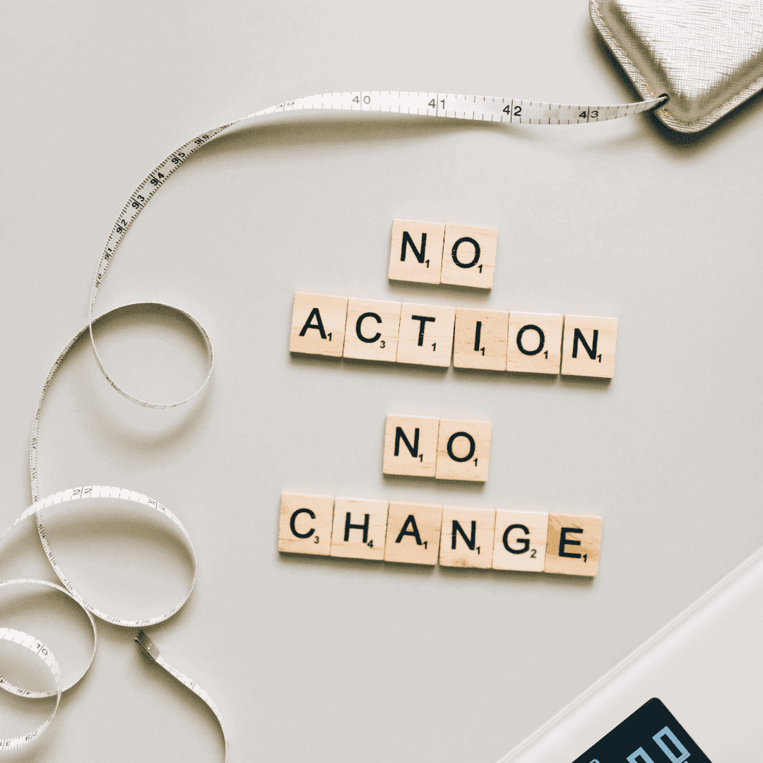 Wooden Scrabble tiles spelling "No Action No Change" with measuring tape and notebook.