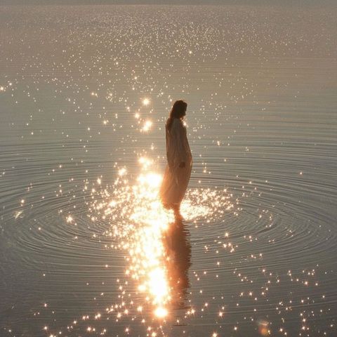 Serene Woman in Sparkling Water at Sunset